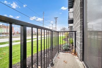 A black metal fence leads to a building entrance.